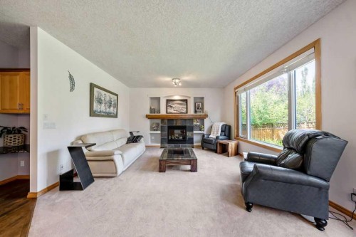 391 Banister Drive, Okotoks, AB - Indoor Photo Showing Living Room With Fireplace