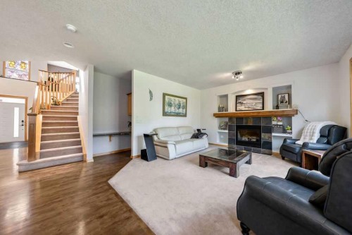 391 Banister Drive, Okotoks, AB - Indoor Photo Showing Living Room With Fireplace