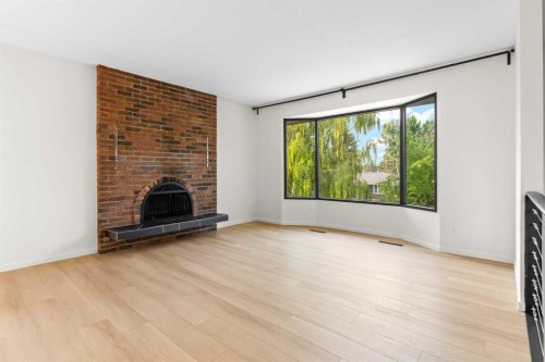 5467 Dalrymple Crescent Nw, Calgary, AB - Indoor Photo Showing Living Room With Fireplace