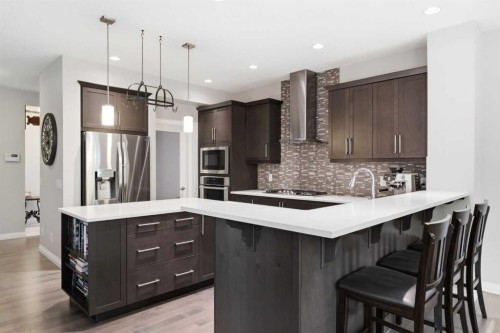 81 Riviera View, Cochrane, AB - Indoor Photo Showing Kitchen With Stainless Steel Kitchen With Upgraded Kitchen