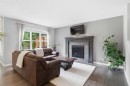 81 Riviera View, Cochrane, AB  - Indoor Photo Showing Living Room With Fireplace 