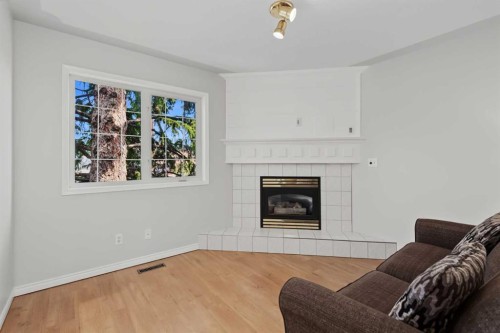 128 22 Avenue Nw, Calgary, AB - Indoor Photo Showing Living Room With Fireplace