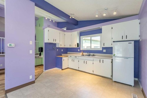 106 Elma Street West, Okotoks, AB - Indoor Photo Showing Kitchen With Double Sink