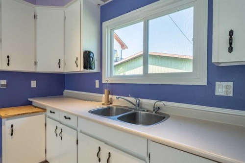 106 Elma Street West, Okotoks, AB - Indoor Photo Showing Kitchen With Double Sink