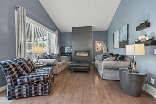 59 Evanswood Circle Nw, Calgary, AB - Indoor Photo Showing Living Room With Fireplace