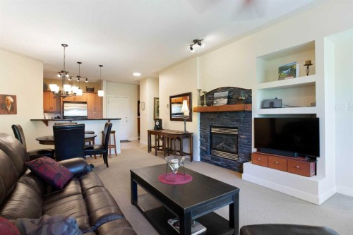 405-10 Discovery Ridge Close Sw, Calgary, AB - Indoor Photo Showing Living Room With Fireplace
