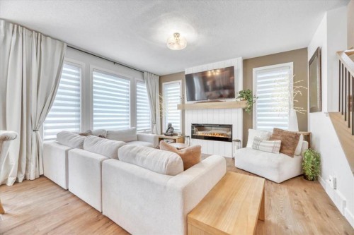 77 Versant Point Sw, Calgary, AB - Indoor Photo Showing Living Room With Fireplace