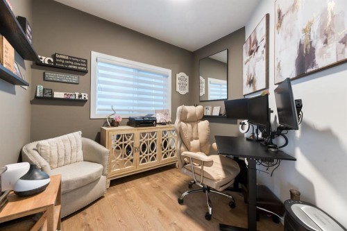 77 Versant Point Sw, Calgary, AB - Indoor Photo Showing Dining Room With Fireplace