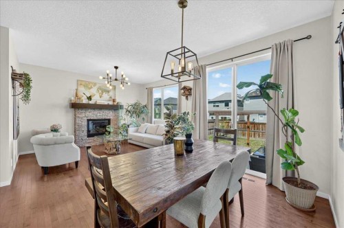 42 Nolancrest Rise Nw, Calgary, AB - Indoor Photo Showing Dining Room With Fireplace