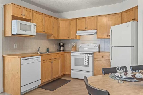 411-160 Kananaskis Way, Canmore, AB - Indoor Photo Showing Kitchen With Double Sink