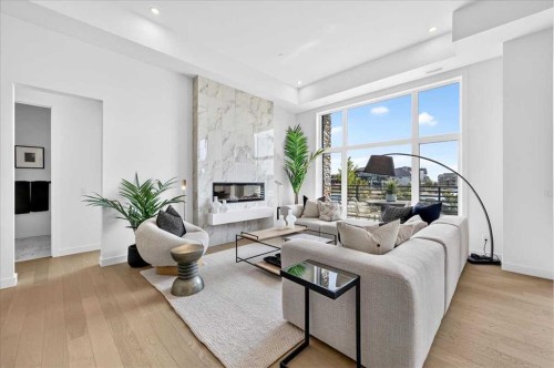 102-150 Marina Cove Se, Calgary, AB - Indoor Photo Showing Living Room With Fireplace