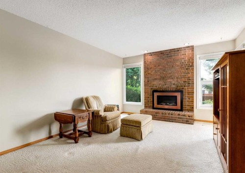 7919 Silver Springs Road Nw, Calgary, AB - Indoor Photo Showing Living Room With Fireplace