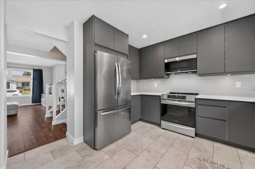 39 Midridge Gardens Se, Calgary, AB - Indoor Photo Showing Kitchen With Stainless Steel Kitchen With Upgraded Kitchen