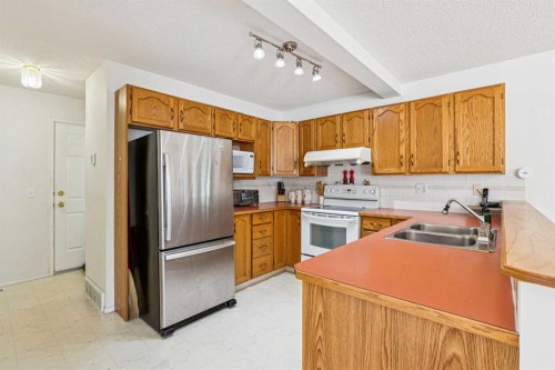 10521 Hidden Valley Drive Nw, Calgary, AB - Indoor Photo Showing Kitchen With Double Sink