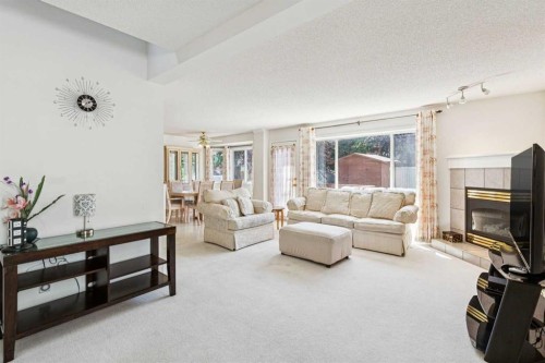 10521 Hidden Valley Drive Nw, Calgary, AB - Indoor Photo Showing Living Room With Fireplace