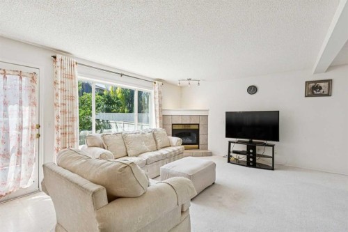 10521 Hidden Valley Drive Nw, Calgary, AB - Indoor Photo Showing Living Room With Fireplace