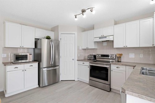 9 Ross Place, Crossfield, AB - Indoor Photo Showing Kitchen With Double Sink