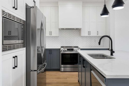 12 Copperhead Garden Se, Calgary, AB - Indoor Photo Showing Kitchen With Stainless Steel Kitchen With Double Sink With Upgraded Kitchen