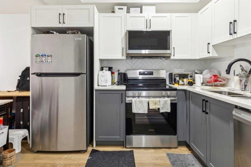 12 Copperhead Garden Se, Calgary, AB - Indoor Photo Showing Kitchen With Stainless Steel Kitchen With Double Sink With Upgraded Kitchen