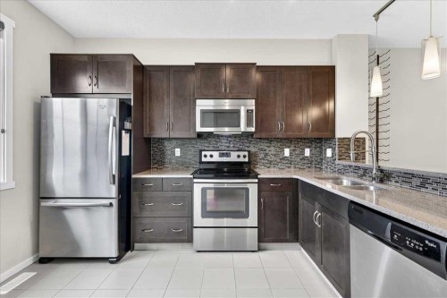 77 Kinlea Way Nw, Calgary, AB - Indoor Photo Showing Kitchen With Stainless Steel Kitchen With Double Sink With Upgraded Kitchen