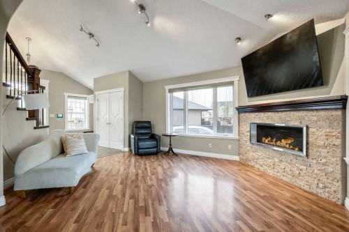 105 Lang Place, Okotoks, AB - Indoor Photo Showing Living Room With Fireplace