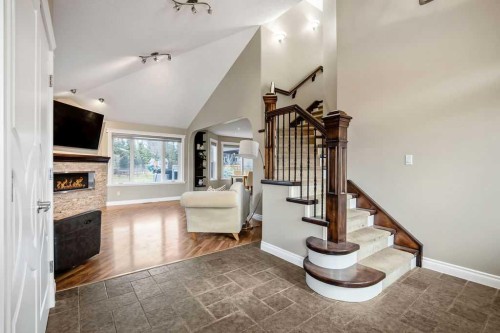 105 Lang Place, Okotoks, AB - Indoor Photo Showing Other Room With Fireplace