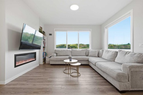 34 Belvedere Green Se, Calgary, AB - Indoor Photo Showing Living Room With Fireplace