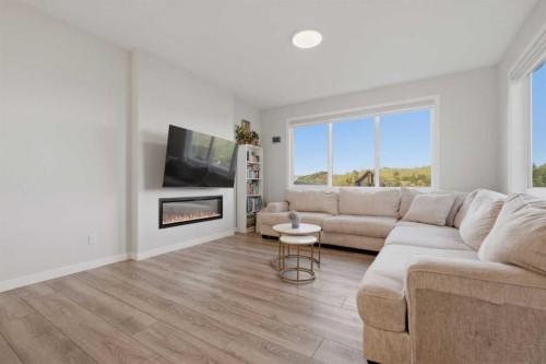 34 Belvedere Green Se, Calgary, AB - Indoor Photo Showing Living Room With Fireplace