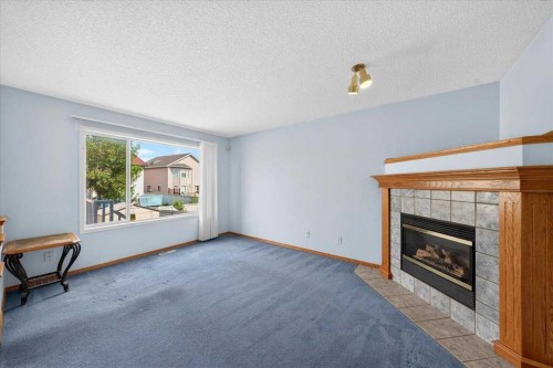 74 Anaheim Gardens Ne, Calgary, AB - Indoor Photo Showing Living Room With Fireplace