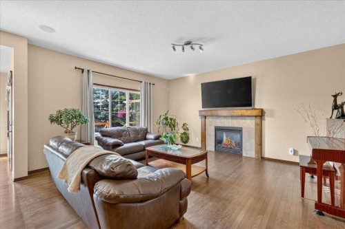 277 Evermeadow Avenue Sw, Calgary, AB - Indoor Photo Showing Living Room With Fireplace