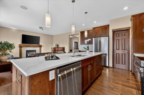 277 Evermeadow Avenue Sw, Calgary, AB - Indoor Photo Showing Kitchen With Fireplace With Stainless Steel Kitchen With Double Sink With Upgraded Kitchen