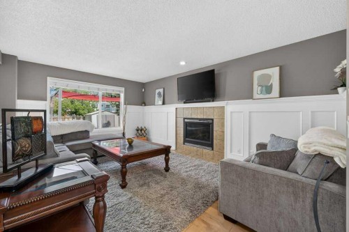 141 Douglas Glen Manor Se, Calgary, AB - Indoor Photo Showing Living Room With Fireplace