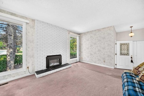6437 Coach Hill Road Sw, Calgary, AB - Indoor Photo Showing Living Room With Fireplace