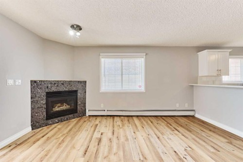 106-126 14 Avenue Sw, Calgary, AB - Indoor Photo Showing Living Room With Fireplace