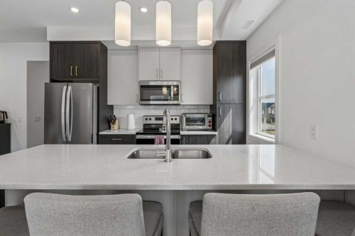 103 Spring Creek Common Sw, Calgary, AB - Indoor Photo Showing Kitchen With Double Sink With Upgraded Kitchen
