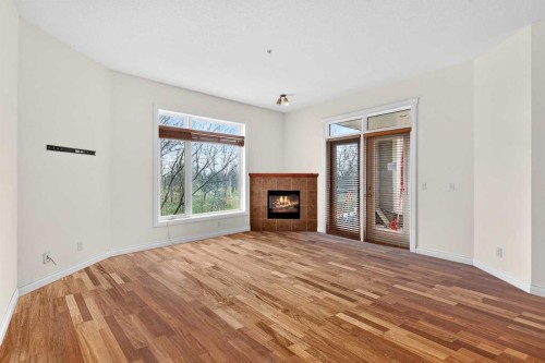 7304-14 Hemlock Crescent Sw, Calgary, AB - Indoor Photo Showing Living Room With Fireplace