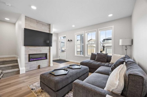 211 Silverton Glen Crescent Sw, Calgary, AB - Indoor Photo Showing Living Room With Fireplace