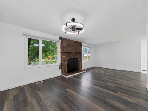 207 Deer Ridge Way Se, Calgary, AB - Indoor Photo Showing Living Room With Fireplace