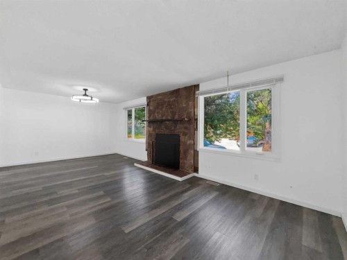 207 Deer Ridge Way Se, Calgary, AB - Indoor Photo Showing Living Room With Fireplace