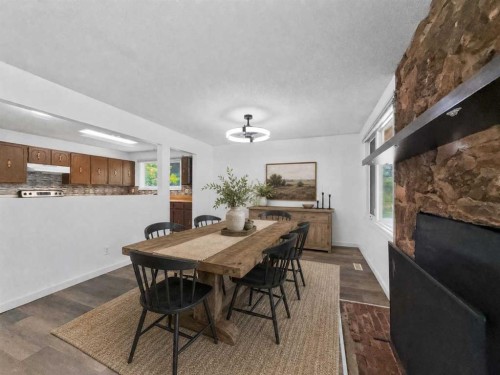 207 Deer Ridge Way Se, Calgary, AB - Indoor Photo Showing Dining Room With Fireplace