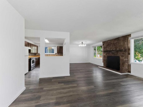 207 Deer Ridge Way Se, Calgary, AB - Indoor Photo Showing Living Room With Fireplace