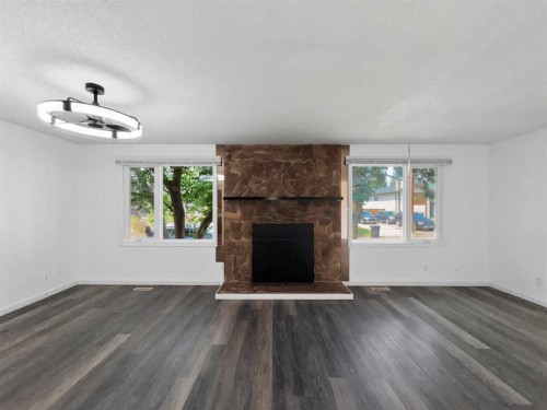 207 Deer Ridge Way Se, Calgary, AB - Indoor Photo Showing Living Room With Fireplace