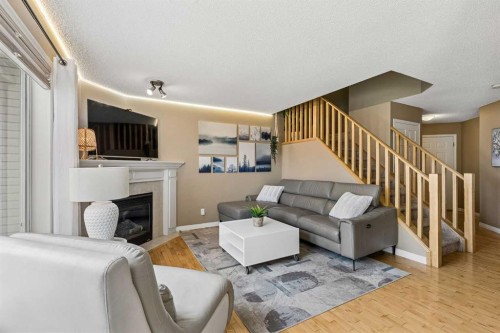 10-117 Bow Ridge Drive, Cochrane, AB - Indoor Photo Showing Living Room With Fireplace