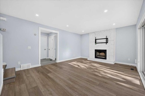 55 Whitehaven Crescent Ne, Calgary, AB - Indoor Photo Showing Other Room With Fireplace
