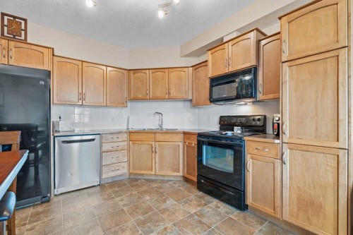 215-43 Sunrise Loop Se, High River, AB - Indoor Photo Showing Kitchen With Double Sink
