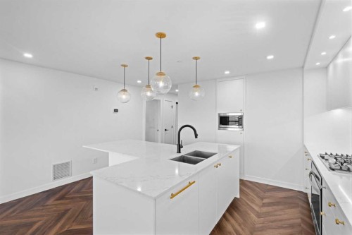 215-8445 Broadcast Avenue Sw, Calgary, AB - Indoor Photo Showing Kitchen With Double Sink With Upgraded Kitchen