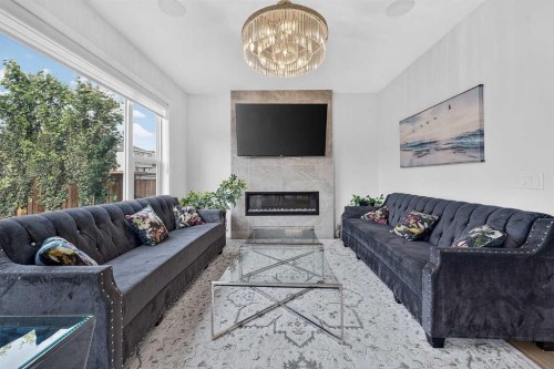 2177 Ravensdun Crescent Se, Airdrie, AB - Indoor Photo Showing Living Room With Fireplace