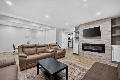 2177 Ravensdun Crescent Se, Airdrie, AB - Indoor Photo Showing Living Room With Fireplace