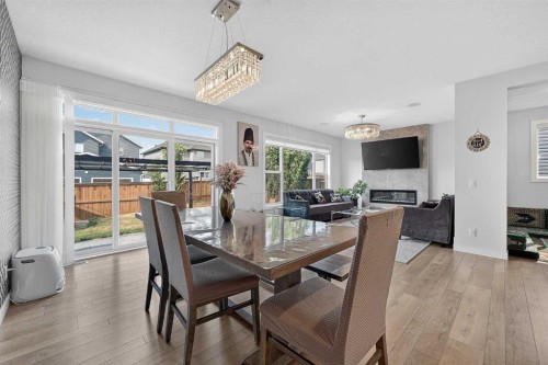 2177 Ravensdun Crescent Se, Airdrie, AB - Indoor Photo Showing Dining Room With Fireplace