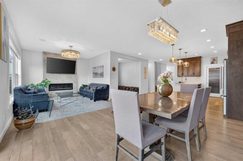 2177 Ravensdun Crescent Se, Airdrie, AB - Indoor Photo Showing Dining Room With Fireplace